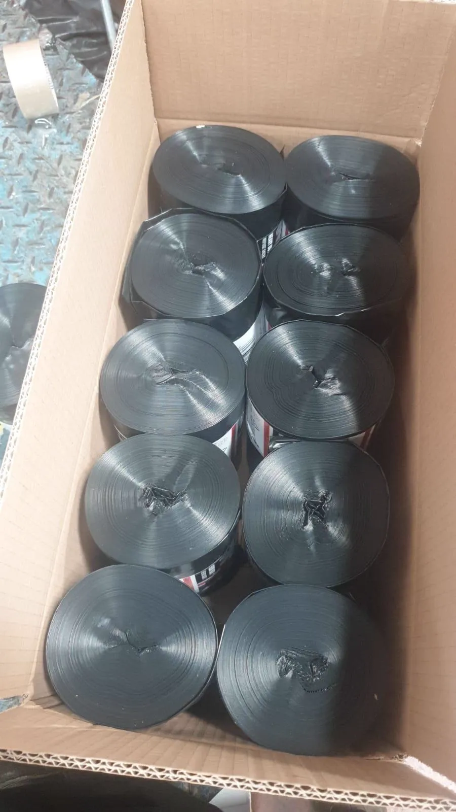 Black plastic bag rolls standing upright in a box
