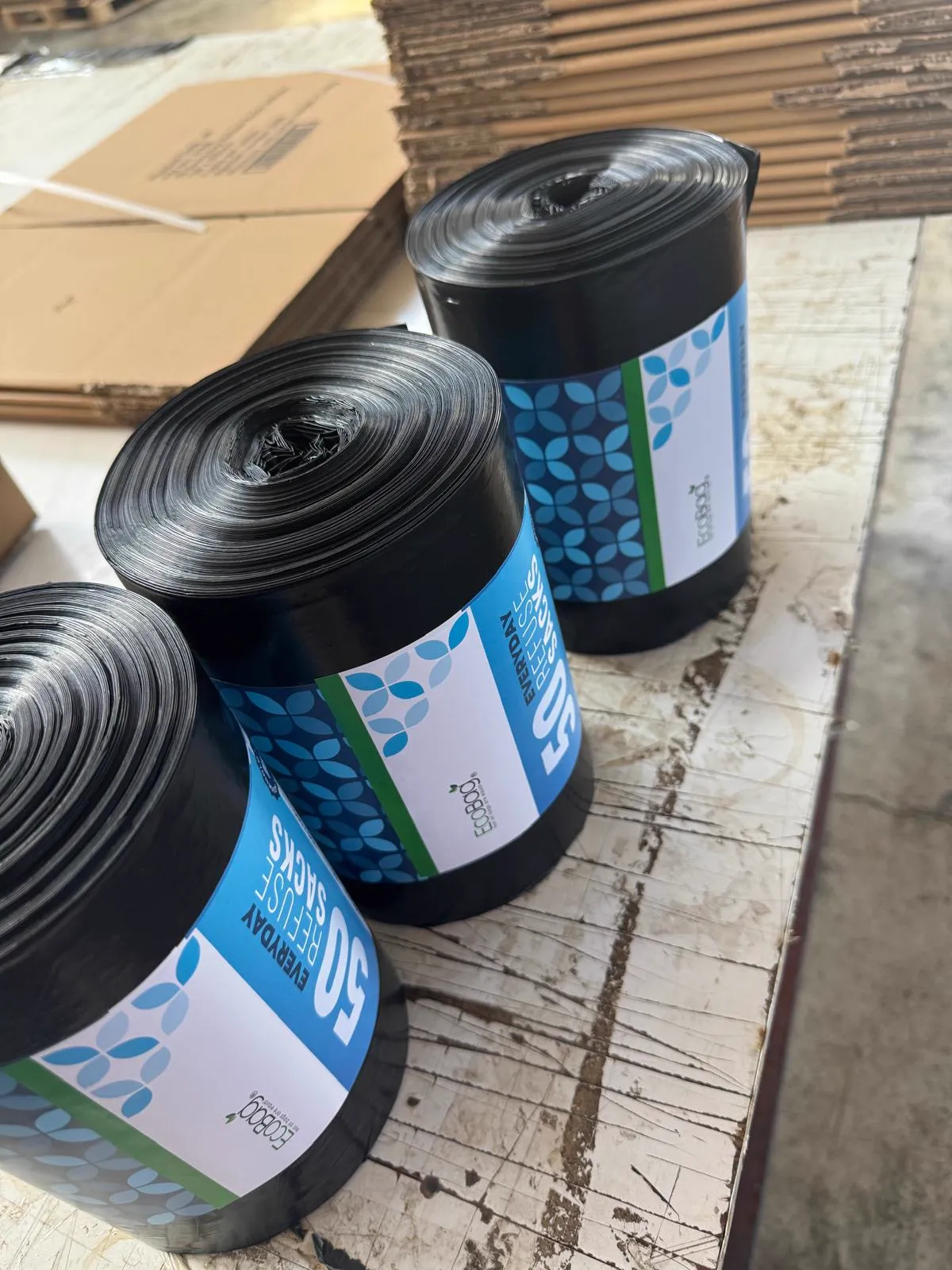 Black refuse sack rolls on a workbench