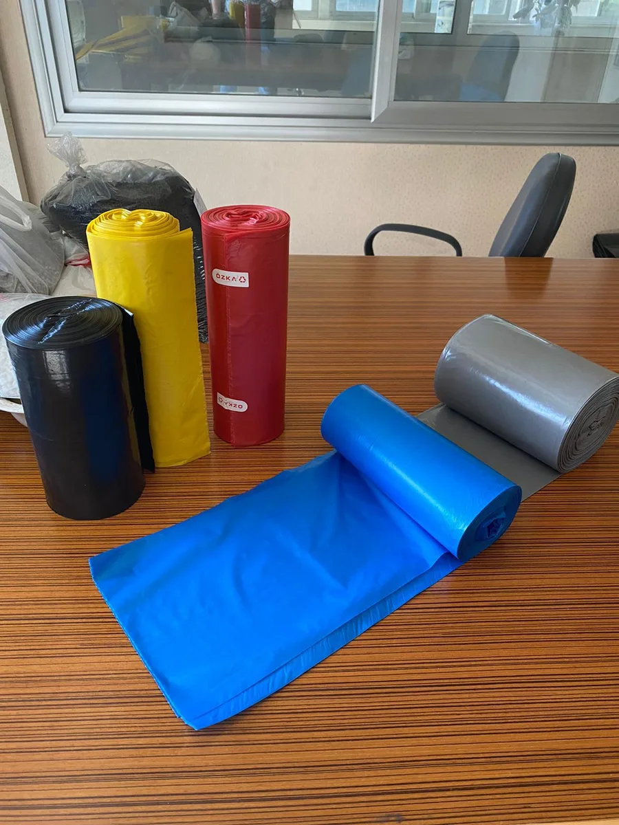 Coloured bin liner rolls in black, yellow, red, blue and grey
